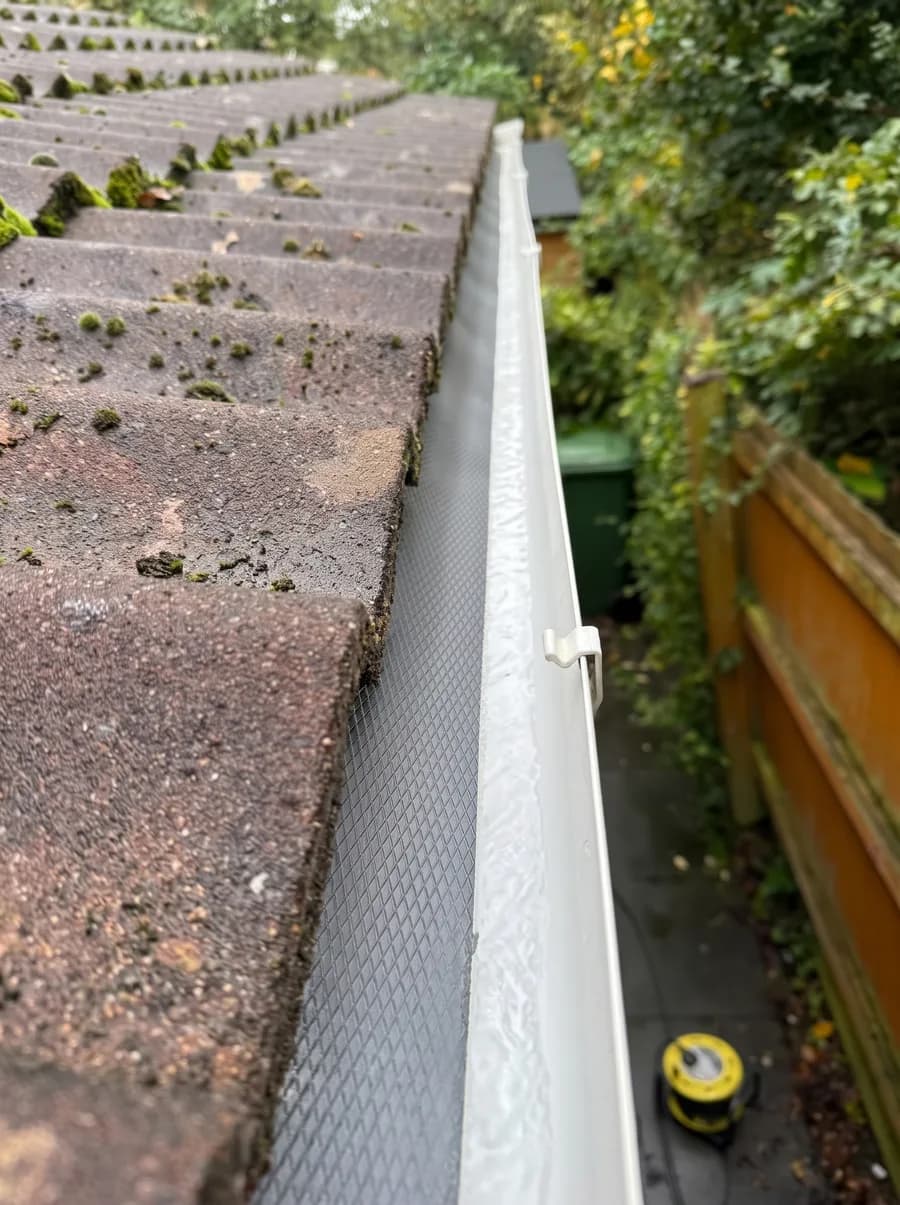 After: Gutter run packed with moss, then the same run cleared